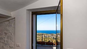 A room with a view of the sea and a balcony with potted plants. - Large panoramic sea view terrace, stone shower, excellence vacation. (Lingueglietta)