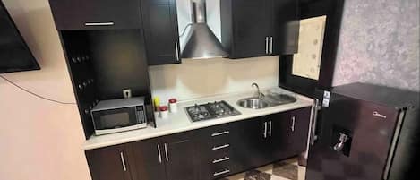 Microwave, coffee/tea maker, cookware/dishes/utensils, dining tables