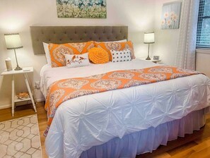 Cozy retreat with a large bed, nightstands, and a beautiful painting.