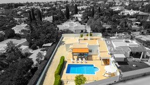 A rooftop pool area with a clear view of the surrounding neighborhood.