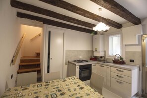 Fridge, stovetop, cookware/dishes/utensils, dining tables