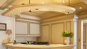 A spacious, well-lit kitchen with a curved island, recessed ceiling lights, and a tiled floor. - AR Boutique Hotel Mannheim City (Mannheim)