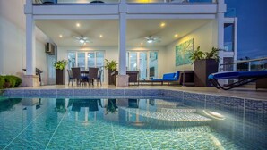 A modern hotel with a pool, outdoor seating, and a balcony with a view. - 4-Bedroom Oceanview Villa | Private Pool & Yard (San Juan del Sur)