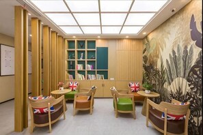 A library with bookshelves, a mural, and seating areas. - Super 8 Hotel (Beijing Xizhimen) (Beijing)