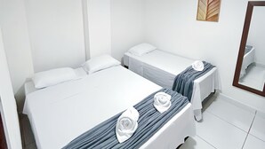 A hotel room with two single beds, white bedding, a mirror, and a ceiling light. - Hotel Paraiso Natal EXPRESS (Natal)