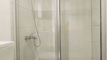 Shower, hair dryer, slippers, towels