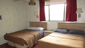 A room with two beds, wooden flooring, a window with red curtains, and a wall-mounted lamp. - Charming hotel in Mayo with AC, WiFi, fitness room (Mayo)