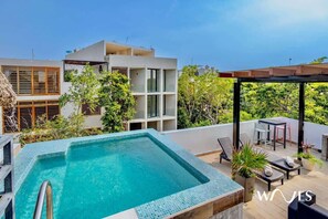 Relax by the pool surrounded by lush greenery and enjoy a tranquil atmosphere.