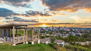 A gazebo with a view of a city skyline at sunset. - Landing | Amazing 2BD, Pool, Clubhouse (Park Hills)
