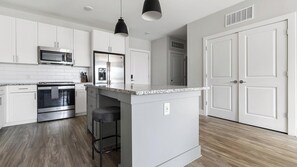 Fridge, dining tables - Landing | Stunning 2BD, Pool, Gym (Matthews)
