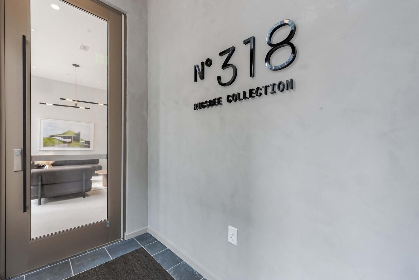 A hallway with a wall-mounted sign reading 'No 318' and 'RESERVE COLLECTION'.