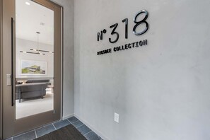 A hallway with a wall-mounted sign reading 'No 318' and 'RESERVE COLLECTION'.
