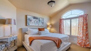 A bedroom with a bed, a bedside table, a lamp, a painting, a window with curtains, and a ceiling light. - Elegant Retreat & Small Gathering Home-Waffles too (Orem)