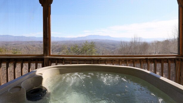 A hot tub with a wooden deck and a view of mountains. - Spectacular Mountain Views Near Dollywood (Sevierville)