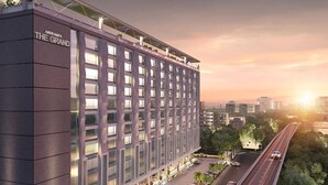 A modern hotel with a flat facade, multiple floors, and a prominent entrance.