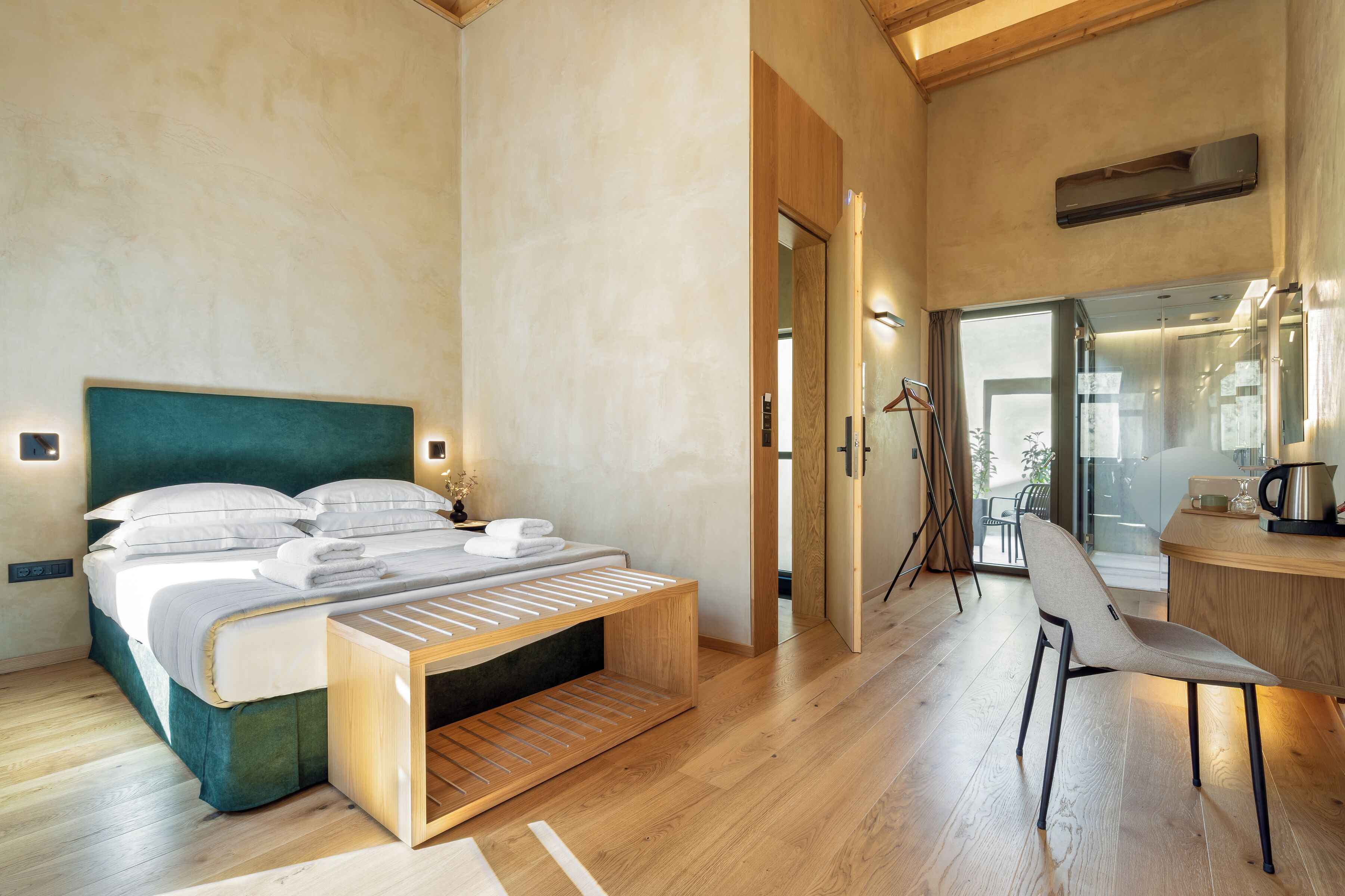 A modern bedroom with a bed, bedside table, and a chair.
