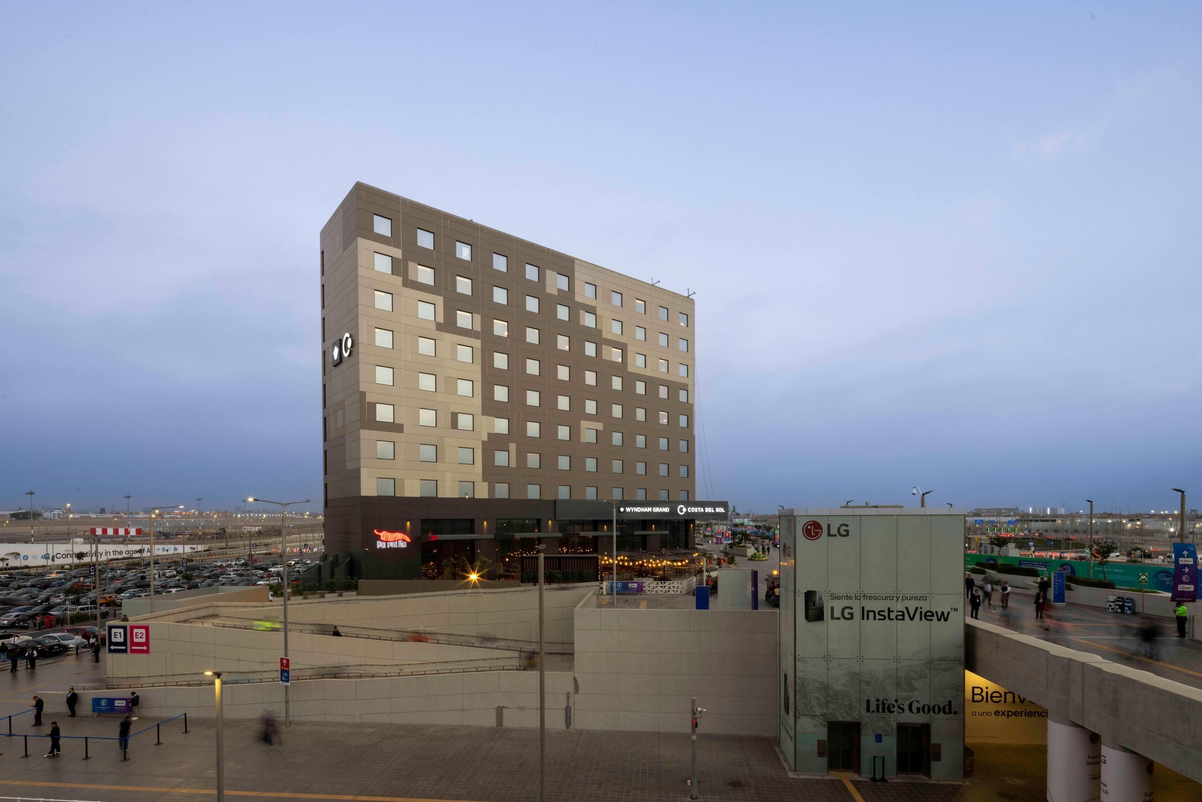 A modern hotel with a flat roof and multiple windows.