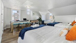 A bedroom with two beds, a desk, and a foosball table. - House of Fun-Large Family Home W/HotTub & Games (Pittsburgh)