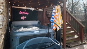A hot tub under a wooden pergola with string lights, a neon sign, and a flag. - House of Fun-Large Family Home W/HotTub & Games (Pittsburgh)