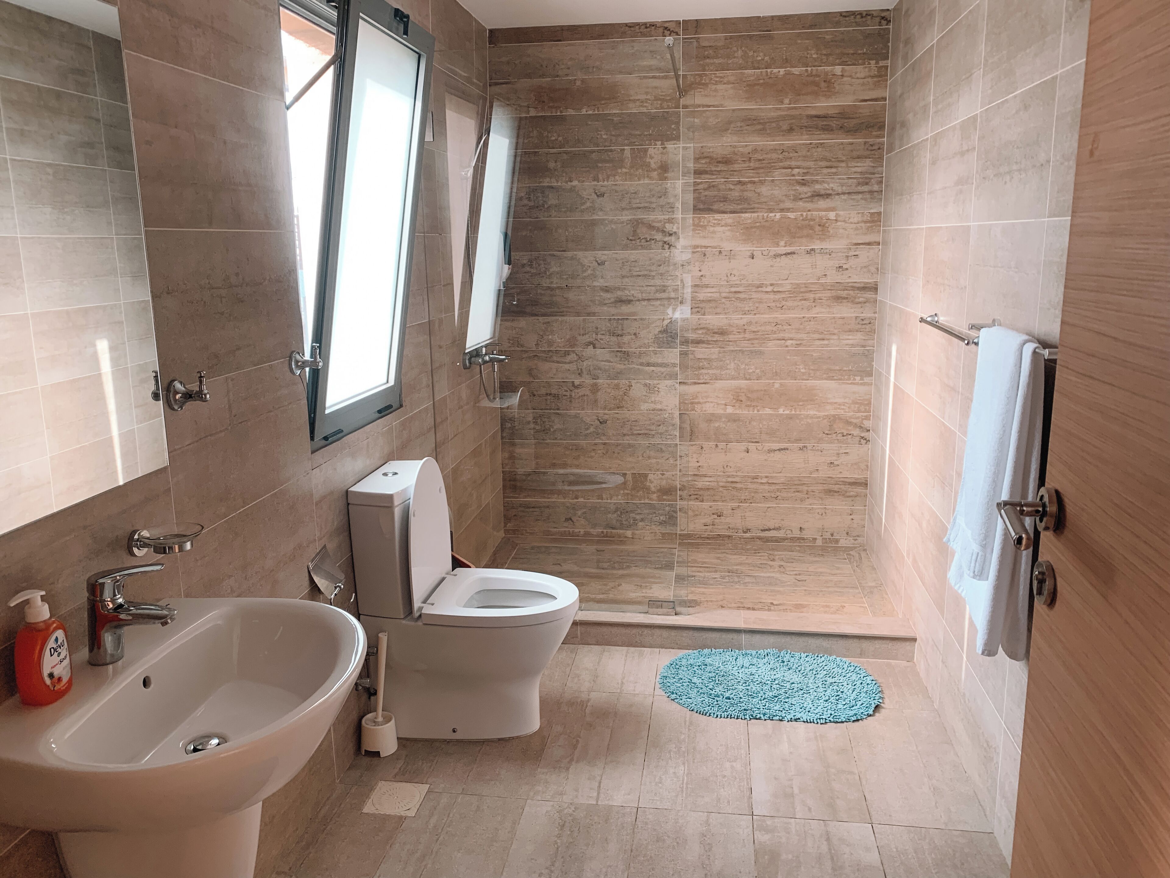 A bathroom with a bathtub, toilet, and shower.