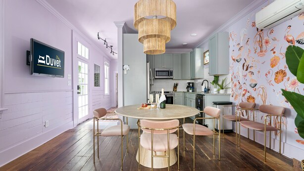 Una cucina moderna con un tavolo rotondo, mobili chiari e un'ampia finestra.