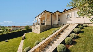 A two-story house with a stone staircase leading to a balcony. - Gorgeous home in Vizinada (Vizinada)