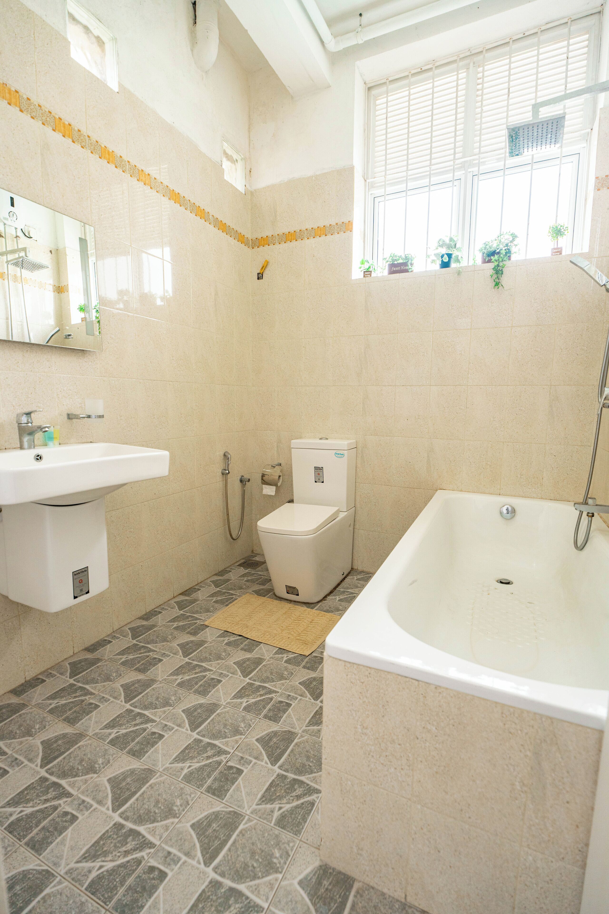 A bathroom with a sink, toilet, and bathtub.