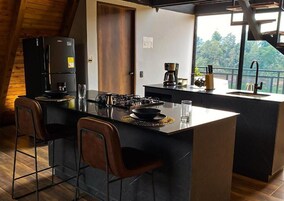 Deluxe Chalet, Lake View | Private kitchen | Coffee/tea maker, electric kettle, dining tables