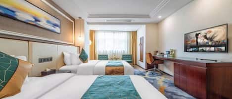 A hotel room with two beds, a desk, and a large painting on the wall.