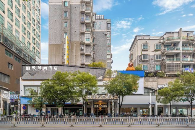 A hotel with a modern facade, a prominent entrance, and a clear sky.