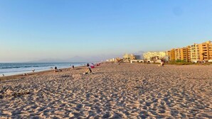 A sandy beach with buildings in the background. - Perfect for digital nomads, families and travelers. Fast WiFi and pools. (La Serena)