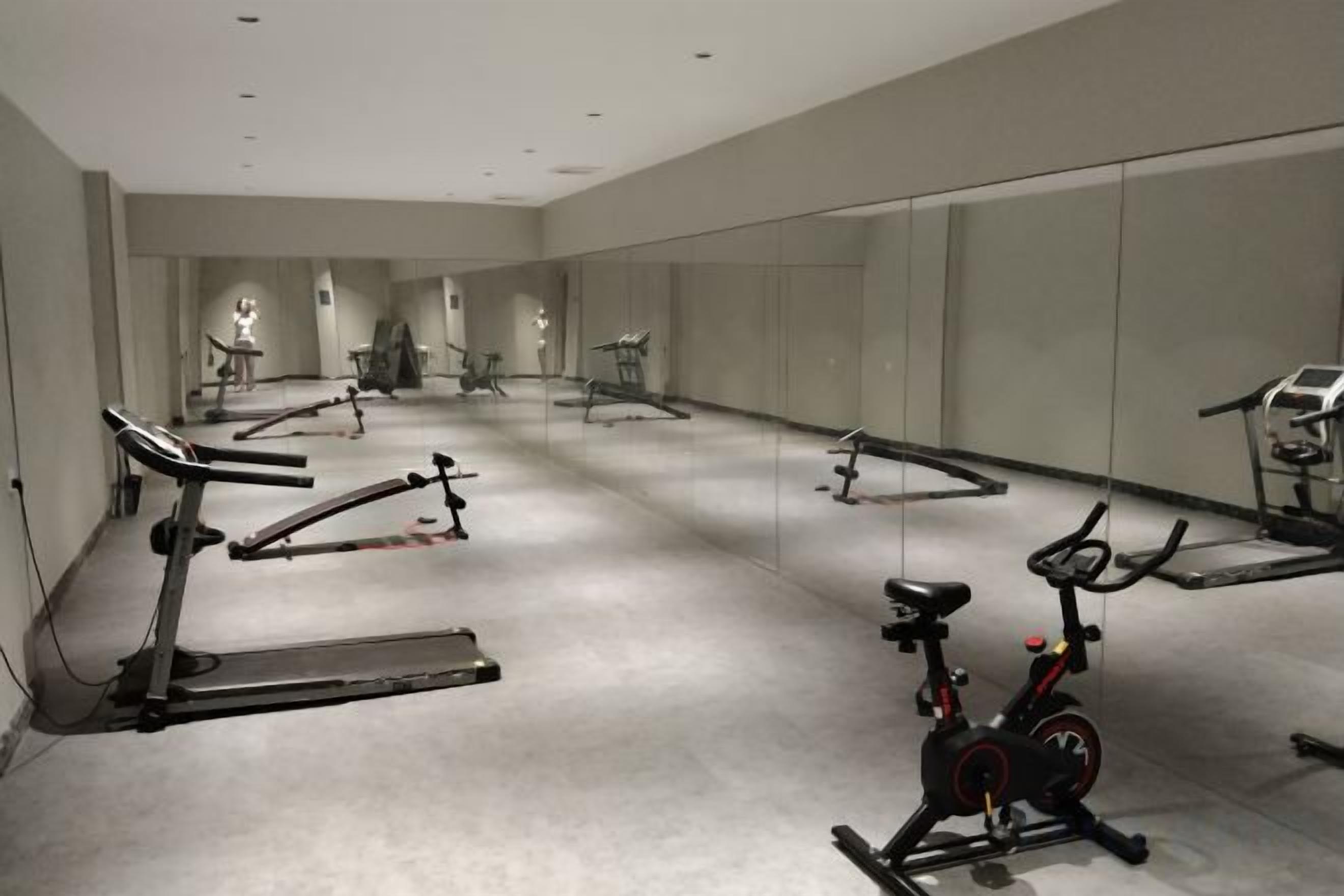 A gym with stationary bikes, treadmills, and exercise equipment.