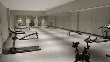 A gym with stationary bikes, treadmills, and exercise equipment.
