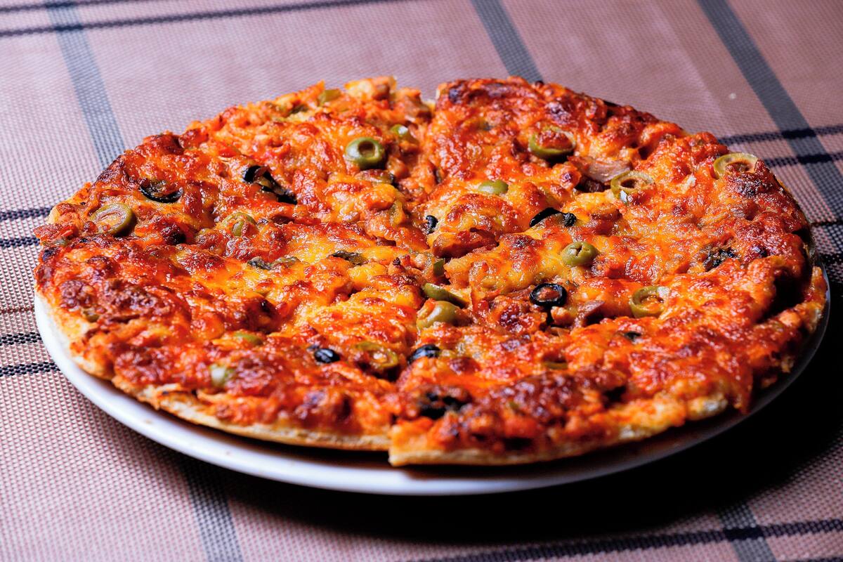 A pizza with various toppings on a plate.