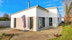 A modern two-story house with a flat roof, large windows, and a chimney. - 3 bedroom gorgeous home in Amfreville (Amfreville)