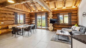 A log cabin interior with a dining area, sofa, and TV. - Awesome home in Waffenbrunn with sauna (Waffenbrunn)