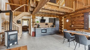 A log cabin interior with a kitchen, dining area, and a staircase. - Awesome home in Waffenbrunn with sauna (Waffenbrunn)