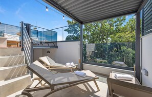 A modern outdoor lounge area with glass walls, a staircase, and a view of trees. - Stunning home in Vodice with sauna (Vodice)