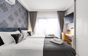 A hotel room with two beds, a desk, a chair, and a TV. - Stunning home in Vodice with sauna (Vodice)