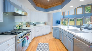 A kitchen with white cabinets, a stove, and a sink. - Expansive 5b6ba Countryside Home in welcoming Galena (Galena)
