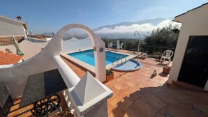 A rooftop pool with a view of mountains, a small seating area, and a potted plant. - Escape & relaxation in the real Spain!
Amazing mountain vistas, pool with views (Cuesta Blanca)