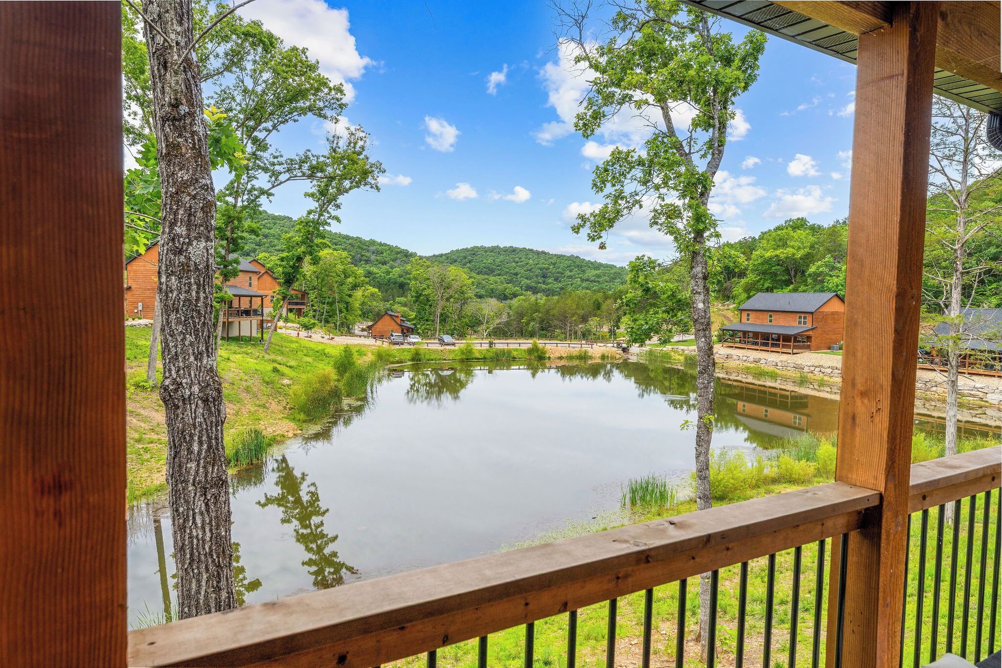 A lakeside view with wooden cabins and a clear sky.