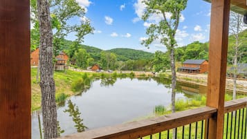 A lakeside view with wooden cabins and a clear sky.