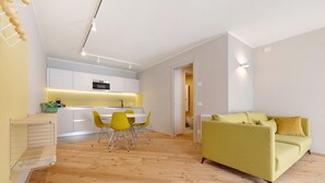 A modern apartment with a kitchen, dining area, and living room.