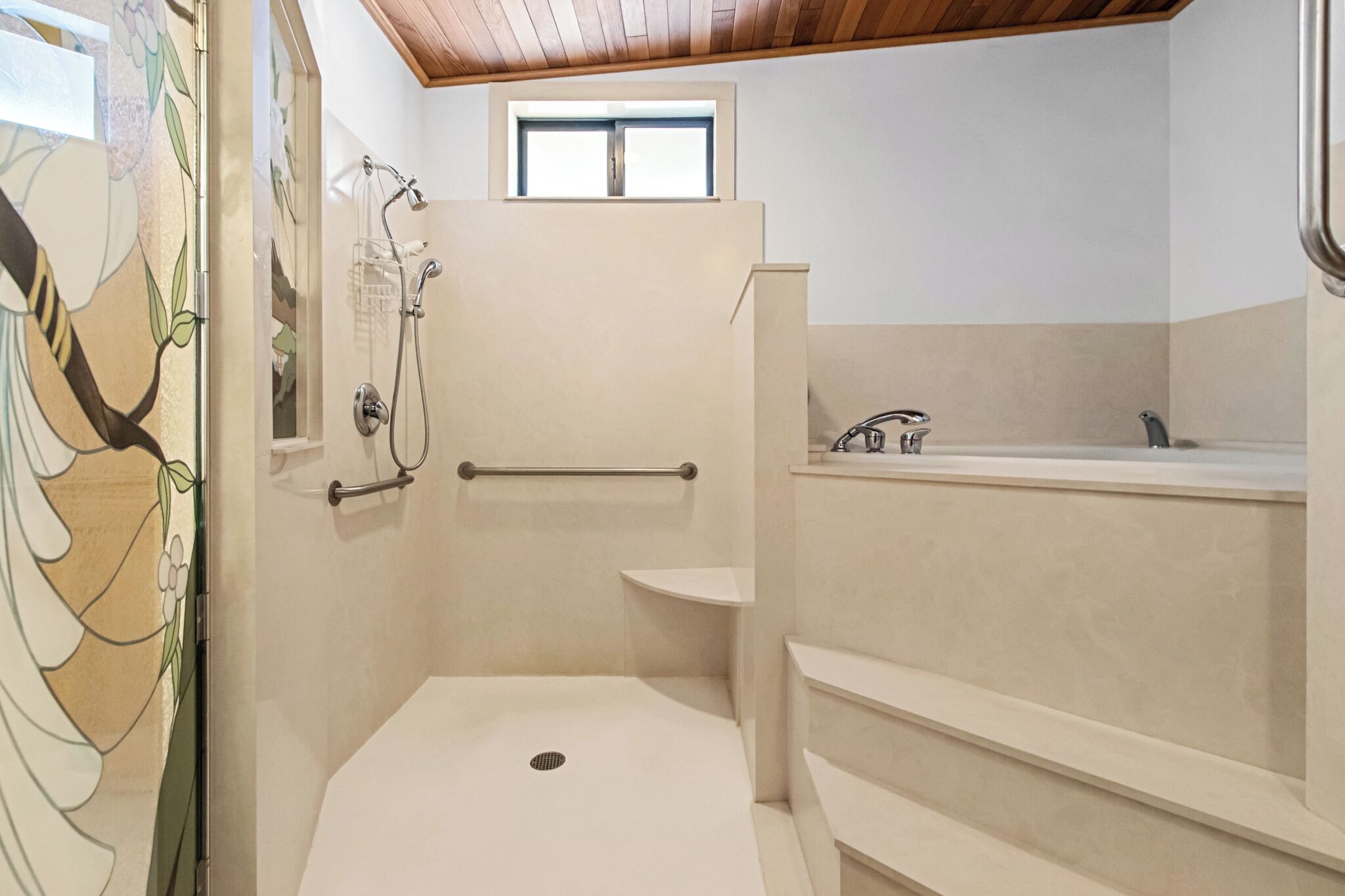 A modern bathroom with a walk-in shower, a bathtub, and a window above the shower.