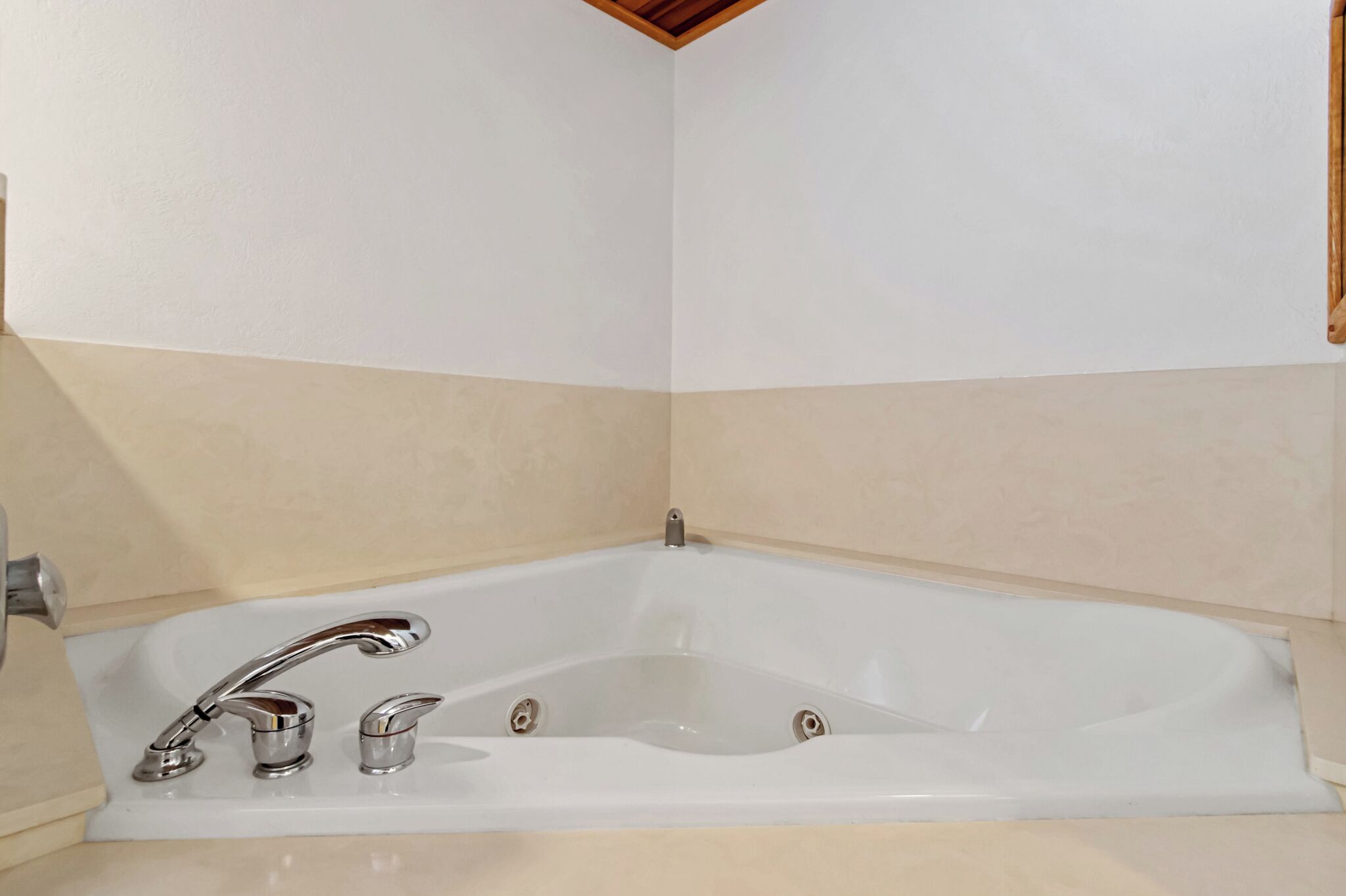 A modern bathroom with a freestanding bathtub, a single faucet, and a showerhead.