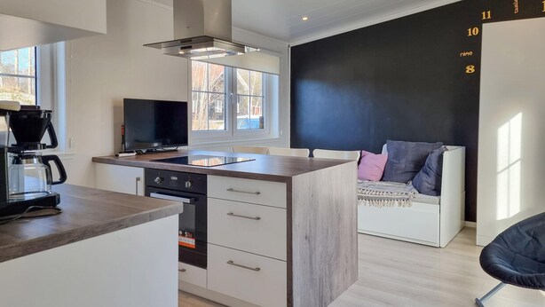A modern kitchen with a central island, a built-in oven, and a coffee maker. - 1 bedroom awesome home in Klövedal (Klövedal)