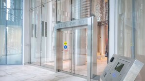 A modern elevator entrance with a digital control panel and a clear sign reading "14 YORK ST".