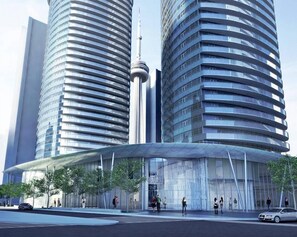 A modern building with a curved facade and a glass entrance. - Beautiful Luxurious Modern Suite (Toronto)