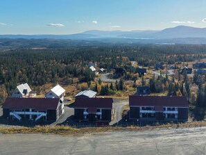 A residential area with houses, a road, and a forested landscape. - Trillevallen 4 by Interhome (Trillevallen)